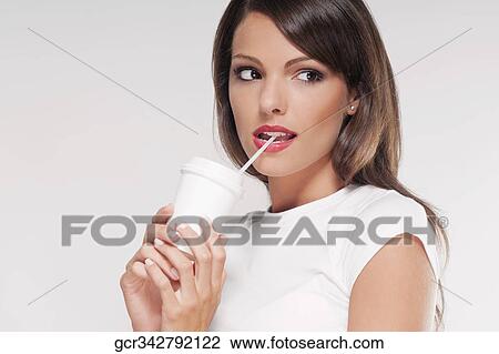 Stock Image - Woman drinking coffee with a straw. Fotosearch
