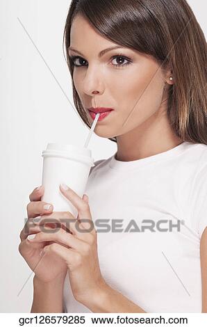 Woman drinking coffee with a straw View Large Photo Image Stock Photography - Woman drinking coffee with a straw. Fotosearch