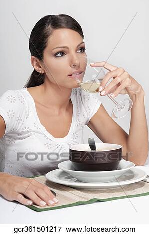 Woman drinking white wine and day dreaming View Large Photo Image Stock Photo - Woman drinking white wine and day dreaming. Fotosearch