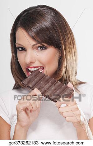 Woman eating a bar of chocolate View Large Photo Image Stock Image - Woman eating a bar of chocolate. Fotosearch