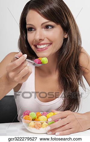 Woman eating a bowl of dry cereal View Large Photo Image Stock Photo - Woman eating a bowl of dry cereal. Fotosearch