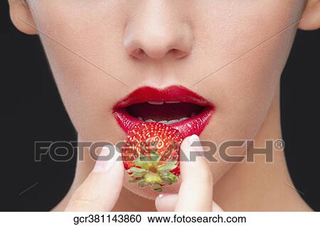 Woman eating a strawberry View Large Photo Image Stock Image - Woman eating a strawberry. Fotosearch