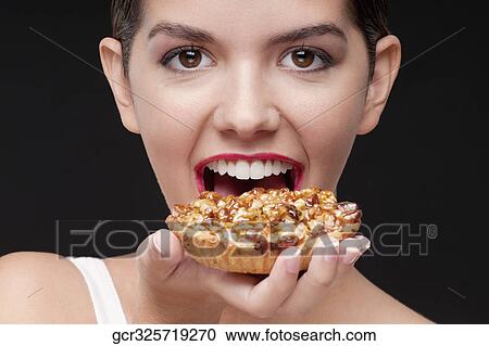Woman eating a tart and smiling View Large Photo Image Stock Image - Woman eating a tart and smiling. Fotosearch