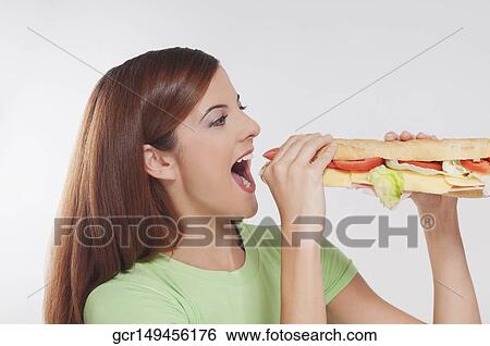 Woman eating hot dog View Large Photo Image Stock Photograph - Woman eating hot dog. Fotosearch