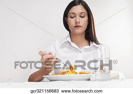 Stock Image - Woman eating pasta. Fotosearch