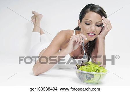 Woman eating salad View Large Photo Image Picture - Woman eating salad. Fotosearch