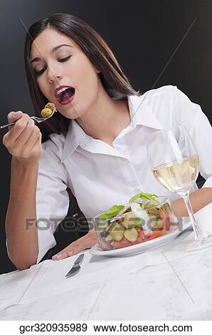 Woman eating salad View Large Photo Image Stock Photo - Woman eating salad. Fotosearch