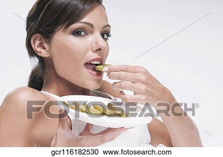 Woman eating sliced kiwi fruit View Large Photo Image Stock Image - Woman eating sliced kiwi fruit. Fotosearch