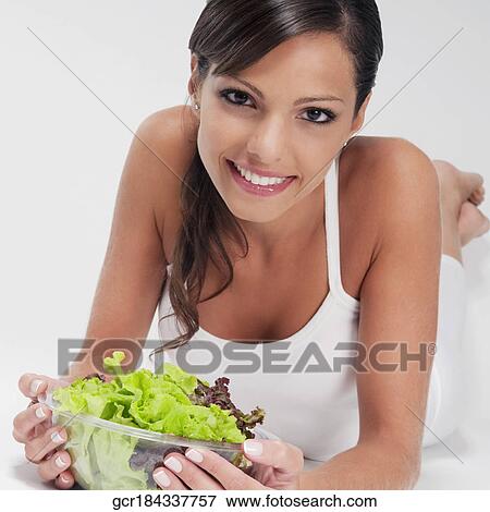 Woman holding a bowl of vegetable salad and smiling View Large Photo Image Stock Photo - Woman holding a bowl of vegetable salad and smiling. Fotosearch