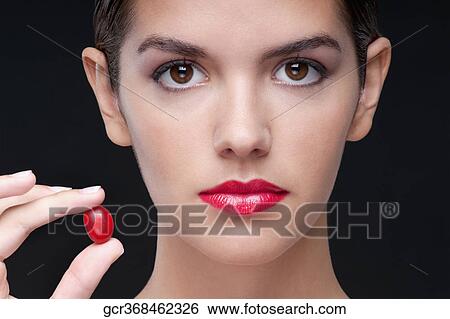 Woman holding a cherry View Large Photo Image Stock Photograph - Woman holding a cherry. Fotosearch