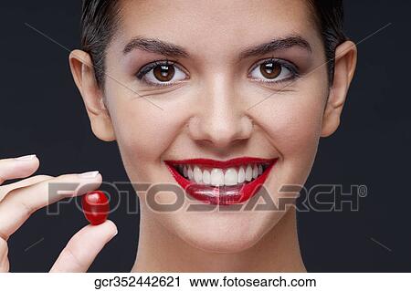 Woman holding a cherry tomato and smiling View Large Photo Image Stock Image - Woman holding a cherry tomato and smiling. Fotosearch