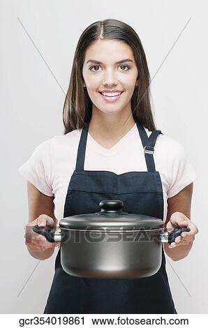 Woman holding a crock pot and smiling View Large Photo Image Stock Image - Woman holding a crock pot and smiling. Fotosearch