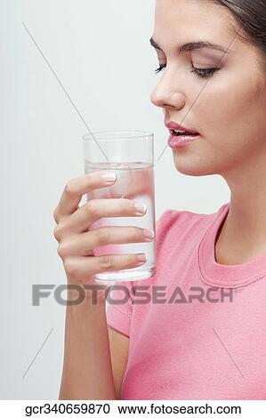 Woman holding a glass of water View Large Photo Image Stock Image - Woman holding a glass of water. Fotosearch