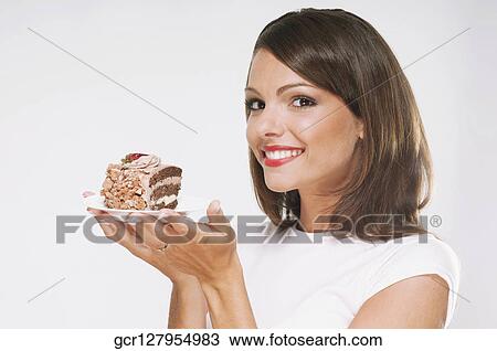 Woman holding a pastry on a plate View Large Photo Image Stock Image - Woman holding a pastry on a plate. Fotosearch