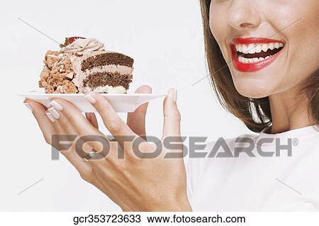 Woman holding a pastry on a plate View Large Photo Image Stock Image - Woman holding a pastry on a plate. Fotosearch