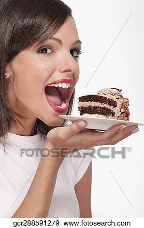 Woman holding a pastry on a plate View Large Photo Image Stock Photo - Woman holding a pastry on a plate. Fotosearch