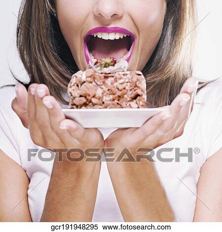 Stock Photography - Woman holding a pastry on a plate. Fotosearch