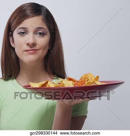 Woman holding a plate of nachos View Large Photo Image Picture - Woman holding a plate of nachos. Fotosearch