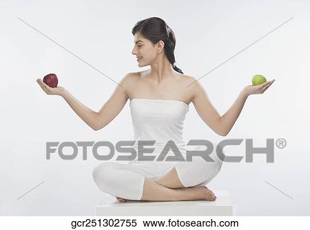Woman holding a red and a green apple View Large Photo Image Stock Photography - Woman holding a red and a green apple. Fotosearch