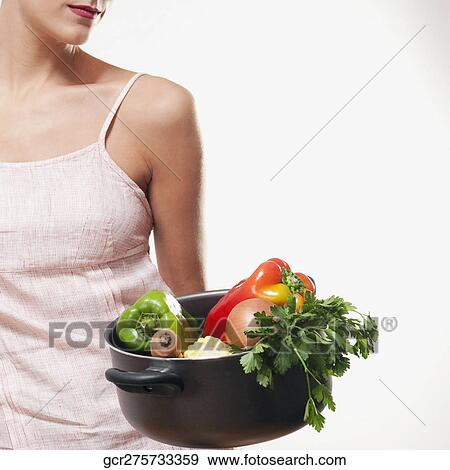 Woman holding a saucepan of fresh vegetables View Large Photo Image Stock Photo - Woman holding a saucepan of fresh vegetables. Fotosearch