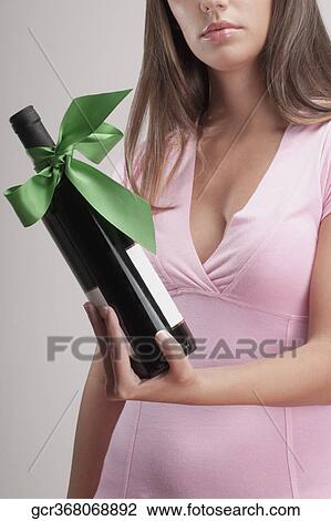 Woman holding a wine bottle View Large Photo Image Stock Image - Woman holding a wine bottle. Fotosearch