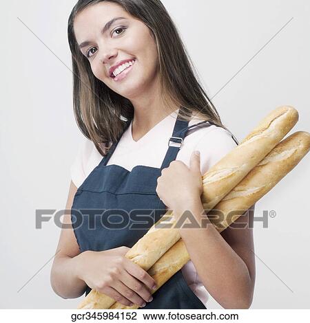 Woman holding baguettes and smiling View Large Photo Image Stock Image - Woman holding baguettes and smiling. Fotosearch