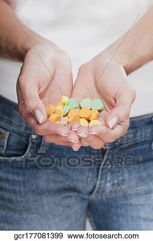 Stock Photo - Woman holding candies. Fotosearch