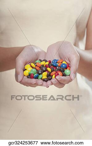 Woman holding candies View Large Photo Image Stock Photo - Woman holding candies. Fotosearch