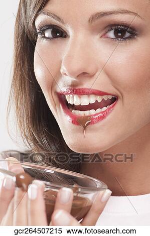 Woman holding chocolate sauce in a bowl View Large Photo Image Stock Photography - Woman holding chocolate sauce in a bowl. Fotosearch