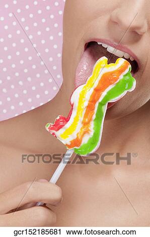 Woman licking candy View Large Photo Image Stock Image - Woman licking candy. Fotosearch