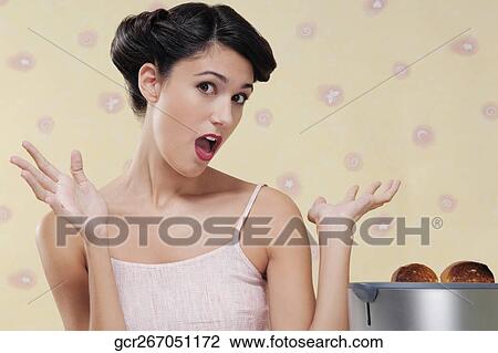 Woman looking surprised in the kitchen View Large Photo Image Stock Image - Woman looking surprised in the kitchen. Fotosearch