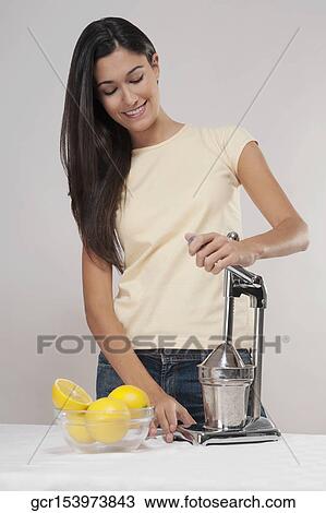 Woman making orange juice View Large Photo Image Stock Image - Woman making orange juice. Fotosearch
