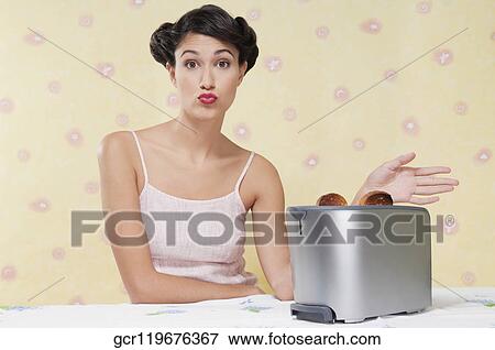 Woman puckering her lips in the kitchen View Large Photo Image Stock Photo - Woman puckering her lips in the kitchen. Fotosearch
