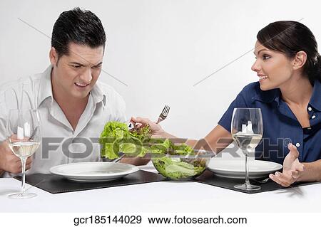 Woman serving salad to a man View Large Photo Image Stock Photo - Woman serving salad to a man. Fotosearch