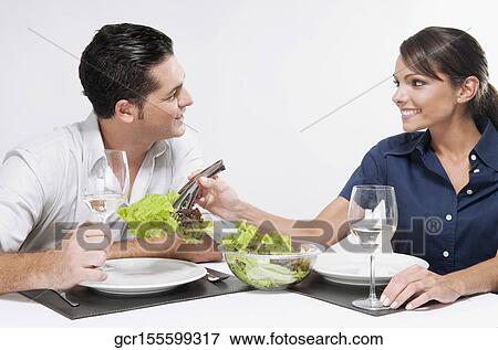 Woman serving salad to her husband View Large Photo Image Stock Photo - Woman serving salad to her husband. Fotosearch