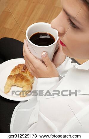 Woman sitting with a cup of coffee and plate of croissants View Large Photo Image Stock Image - Woman sitting with a cup of coffee and plate of croissants. Fotosearch