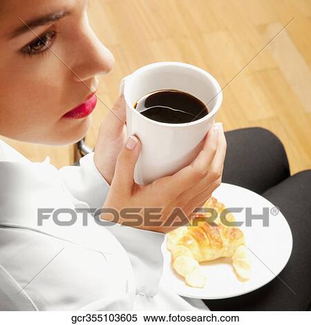 Woman sitting with a cup of coffee and plate of croissants View Large Photo Image Stock Photography - Woman sitting with a cup of coffee and plate of croissants. Fotosearch