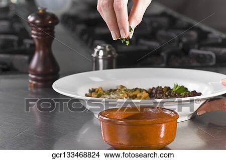 Woman sprinkling cilantro to beans View Large Photo Image Picture - Woman sprinkling cilantro to beans. Fotosearch