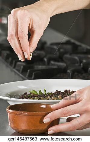 Woman sprinkling cilantro to beans View Large Photo Image Stock Image - Woman sprinkling cilantro to beans. Fotosearch
