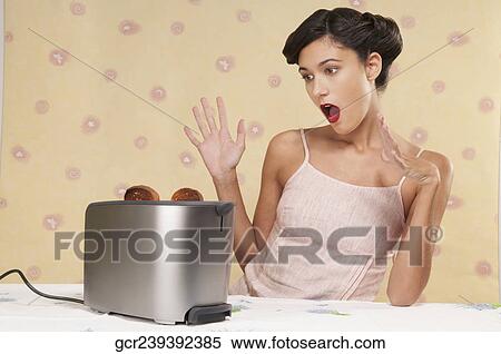 Woman surprised by a pop up toaster View Large Photo Image Stock Photography - Woman surprised by a pop up toaster. Fotosearch