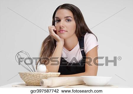 Woman thinking with a basket of eggs and a rolling pin View Large Photo Image Stock Image - Woman thinking with a basket of eggs and a rolling pin. Fotosearch