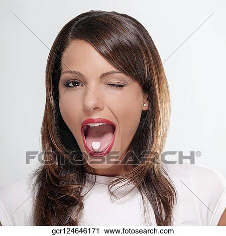 Woman winking with mint candy on her tongue View Large Photo Image Stock Image - Woman winking with mint candy on her tongue. Fotosearch
