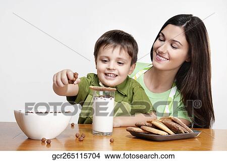 Woman with her son at a breakfast table View Large Photo Image Picture - Woman with her son at a breakfast table. Fotosearch