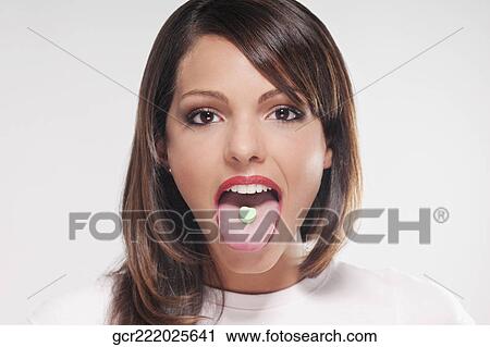 Woman with mint candy on her tongue View Large Photo Image Stock Image - Woman with mint candy on her tongue. Fotosearch