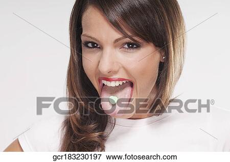 Woman with mint candy on her tongue View Large Photo Image Stock Photo - Woman with mint candy on her tongue. Fotosearch
