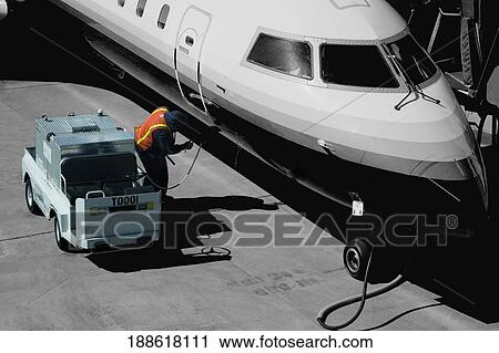 Airplane being refueled at an airport View Large Photo Image Stock Image - Airplane being refueled at an airport. Fotosearch
