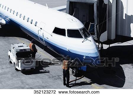 Airplane being refueled at an airport View Large Photo Image Stock Image - Airplane being refueled at an airport. Fotosearch