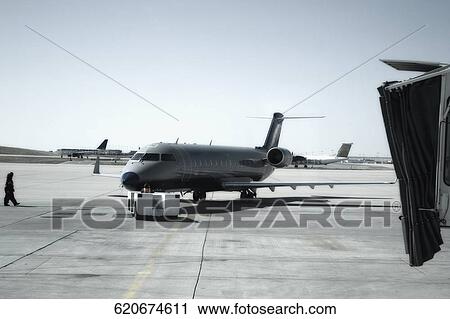 Airplane being refueled at an airport View Large Photo Image Stock Image - Airplane being refueled at an airport. Fotosearch