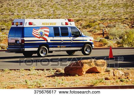 Ambulance on the road passing through an arid landscape, Las Vegas, Nevada, USA View Large Photo Image Stock Photo - Ambulance on the road passing through an arid landscape, Las Vegas, Nevada, USA. Fotosearch