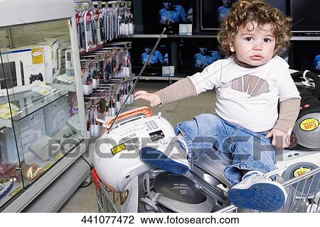 Baby boy sitting on a shopping cart in a supermarket View Large Photo Image Stock Image - Baby boy sitting on a shopping cart in a supermarket. Fotosearch